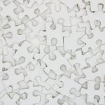 Plain white jigsaw pieces overlapping each other